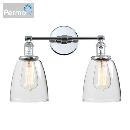 Chrome-finished vintage wall sconce with two clear glass shades and exposed filament bulbs for bedroom lighting