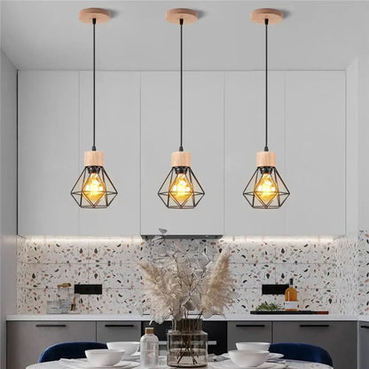 Three vintage black wood and iron cage pendant lights with warm bulbs for dining room use in small square meters