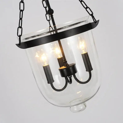 Black vintage pendant lamp with wrought iron frame clear glass enclosure and three exposed filament bulbs for dining room decorbites