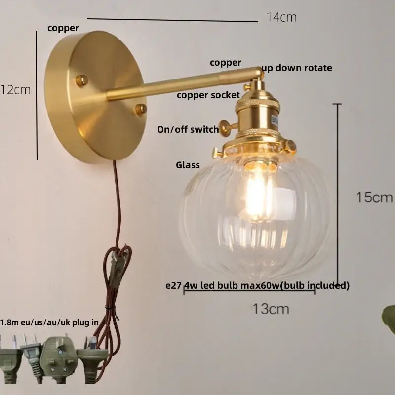 Brass-finished copper wall lamp with clear globe shade and adjustable arm featured in decorbites blue glass collection