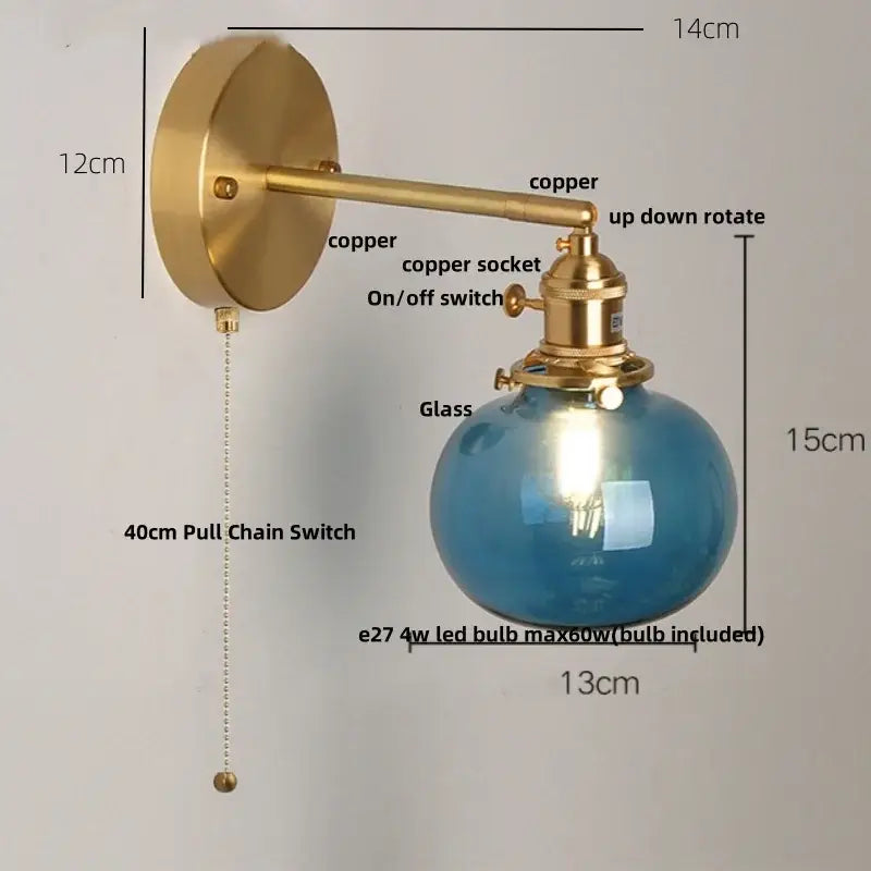 Vintage blue glass wall lamp with brass-finished copper arm and spherical shade from decorbites blue glass collection
