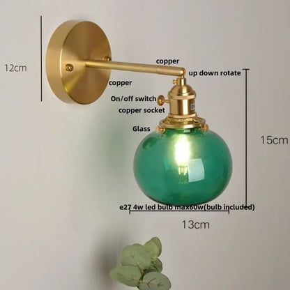 Vintage blue glass wall lamp with brass-finished copper arm and spherical green glass globe for decorbites blue glass decor