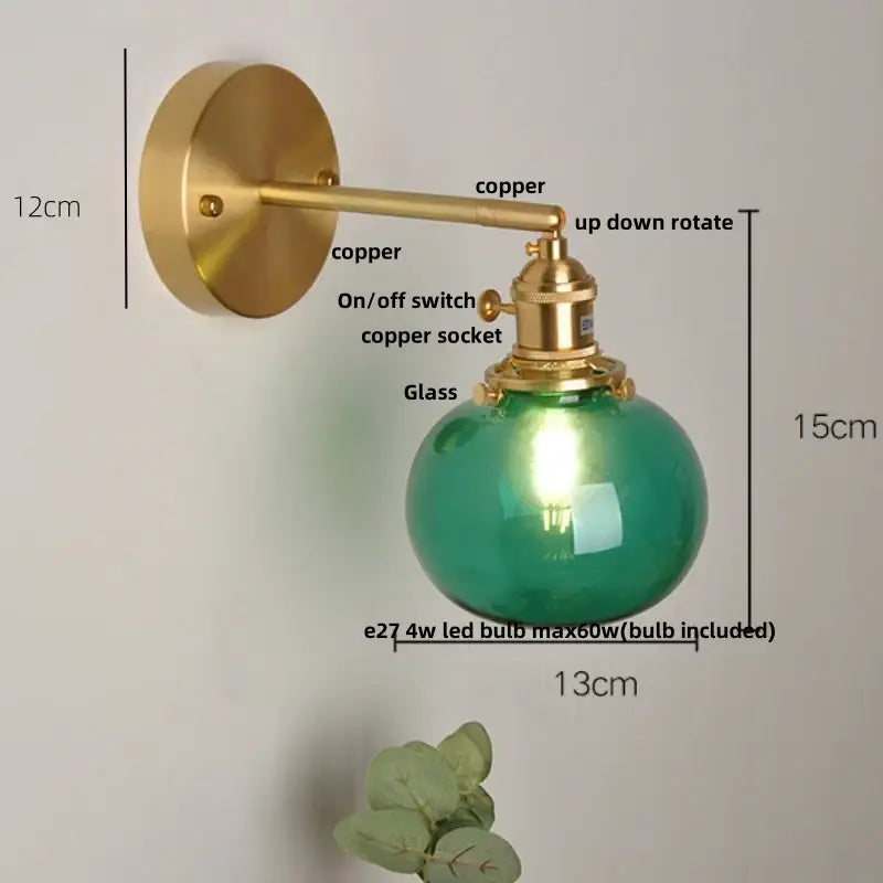Vintage blue glass wall lamp with brass-finished copper arm and spherical green glass globe for decorbites blue glass decor