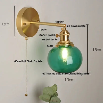 Vintage wall lamp with a brass copper arm and spherical blue glass globe featuring an led bulb for bedroom decorbites blue glass