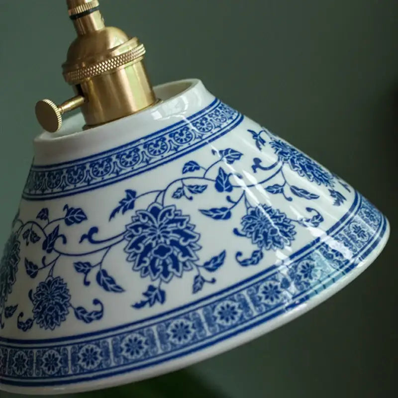 White ceramic pendant lamp with intricate blue floral vines and brass socket ideal for dining room decorbites ceramic led