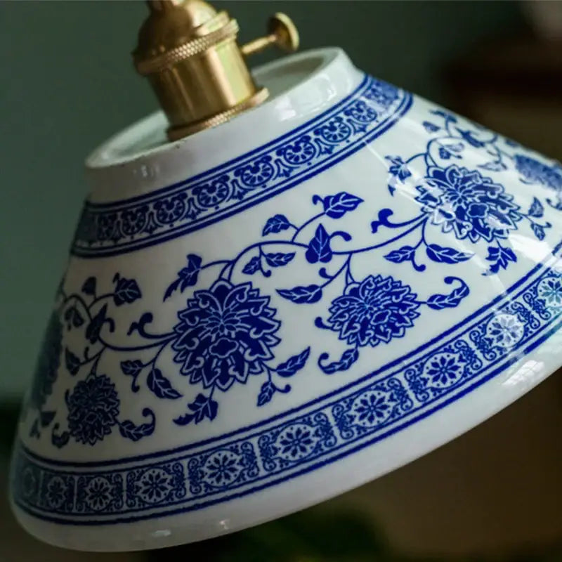 Vintage blue and white ceramic pendant lamp with intricate floral patterns and gold-toned decorbites ceramic led fixture
