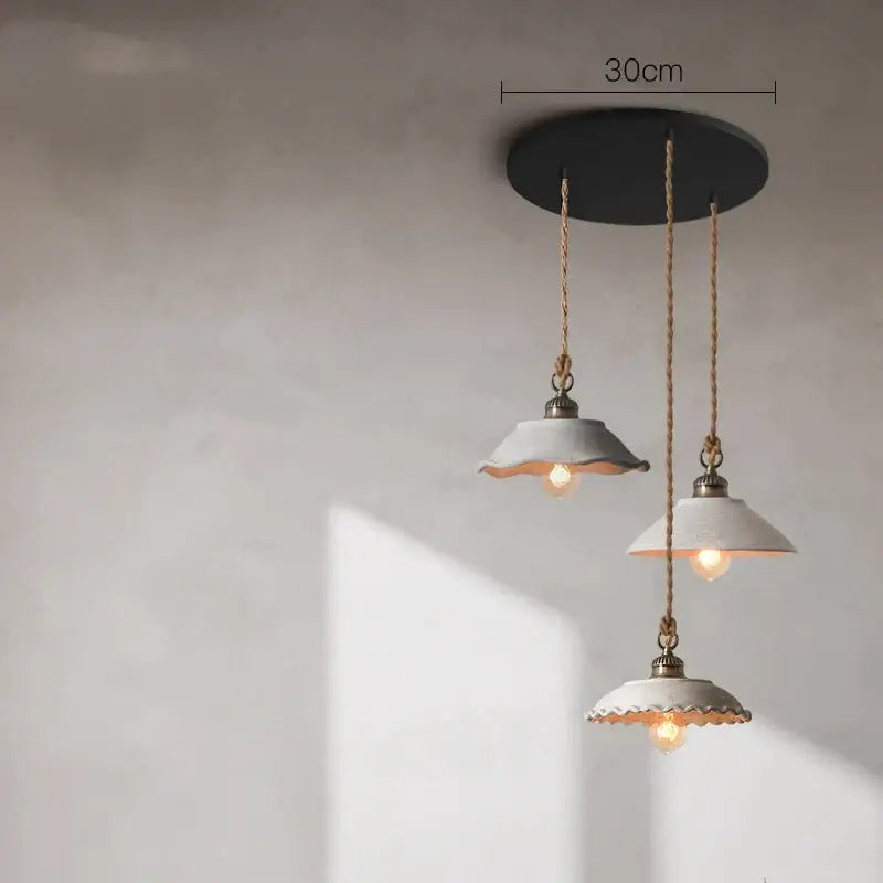 Three ceramic vintage hanging pendant lights with white scalloped shades and brass accents for kitchen decorbites decor