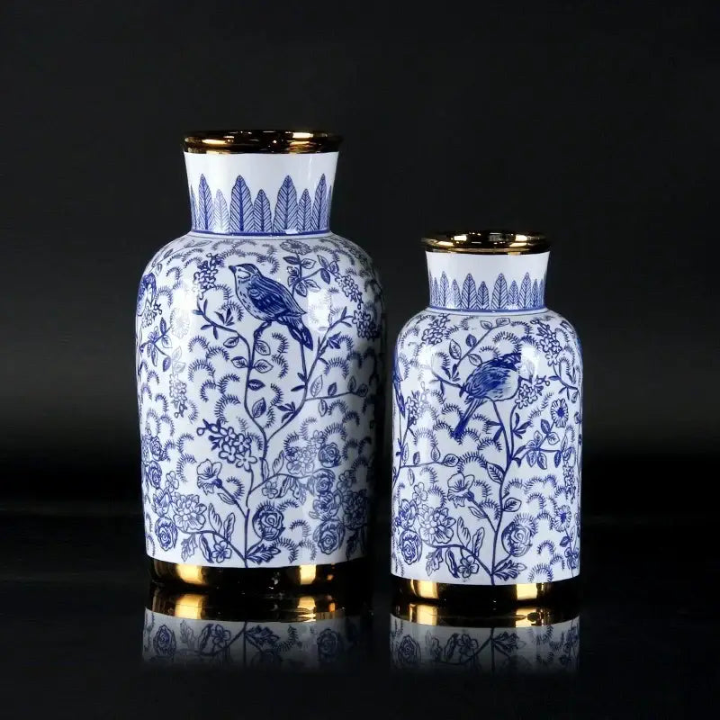 Vintage blue and white porcelain ceramic vase with gold-trimmed rims and intricate bird and floral designs for home decor