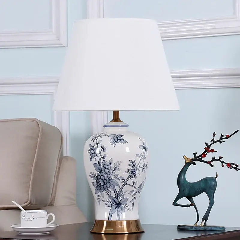 White porcelain table lamp with blue floral design and gold toned base for vintage decorbites blue white decor