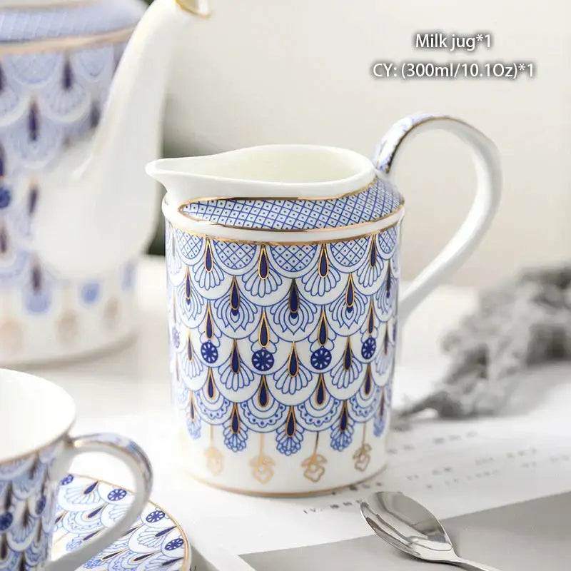 Vintage bone china milk jug with gold trim featuring intricate blue and gold fan patterns and an elegant handle by decorbites bone china