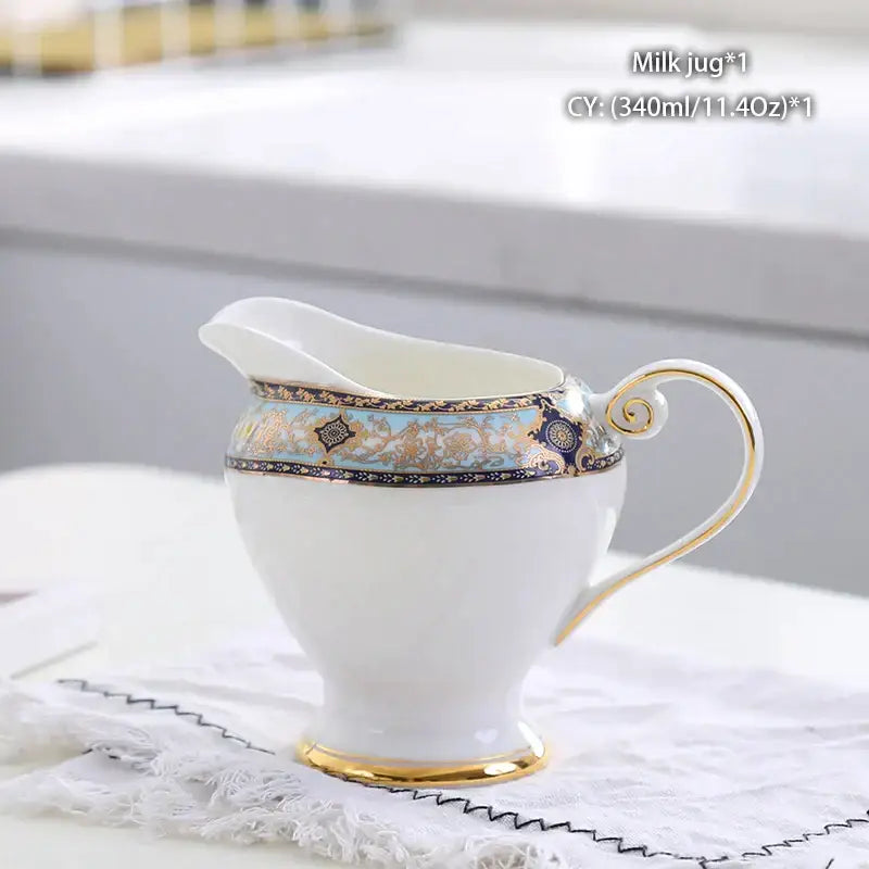 Vintage bone china milk jug with gold trim and intricate blue and turquoise decorative band for dining room use