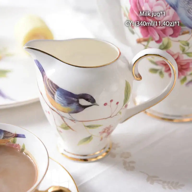 Vintage bone china milk jug with gold trim and a painted blue yellow and black bird for dining room decorbites bone china