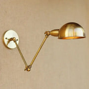 Vintage brass adjustable long arm wall light featuring a dome-shaped lampshade and decorative joints for bedroom decorbites adjustable long use