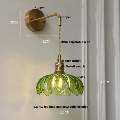 Vintage brass wall sconce with copper arm and adjustable wire featuring a green glass amber coffee glass lampshade