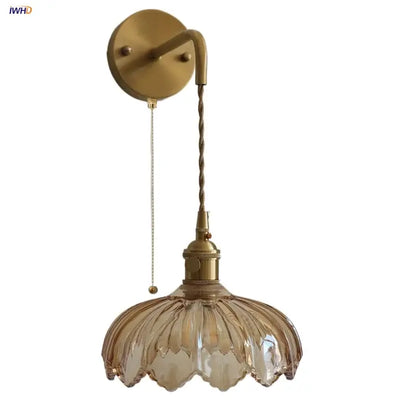 Vintage brass wall sconce with amber coffee glass petal-shaped shade and twisted cord for bedroom lighting