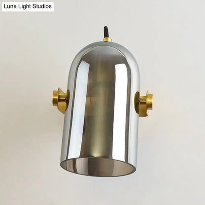 Modern chrome-finished pendant light with brass accents and dome design as a swivel shade cloche bedside sconce