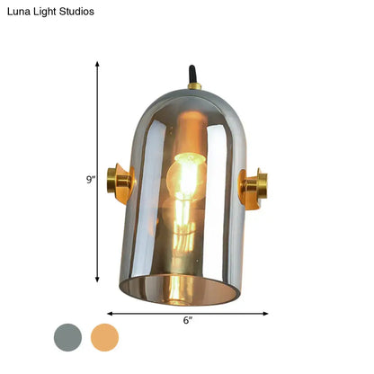 A sleek vintage brass amber swivel shade cloche bedside sconce with metallic dome and gold-toned accents for bedroom