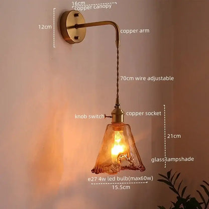 Copper led wall sconce with twisted wire arm, brass canopy, and amber glass copper led lampshade for bedroom lighting