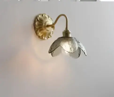 Vintage brass and amber glass led wall lamp with gold-toned brass and translucent glass flower shade for bedroom sconce
