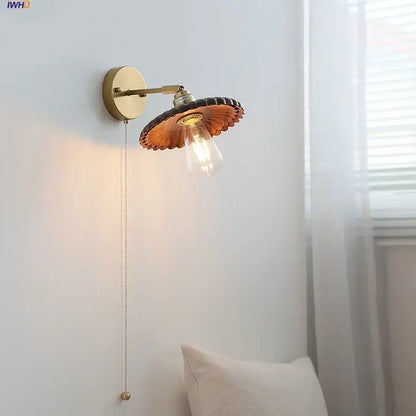 Vintage brass wall lamp with scalloped amber glass shade and exposed Edison bulb enhancing walnut wood decorbites LED walnut