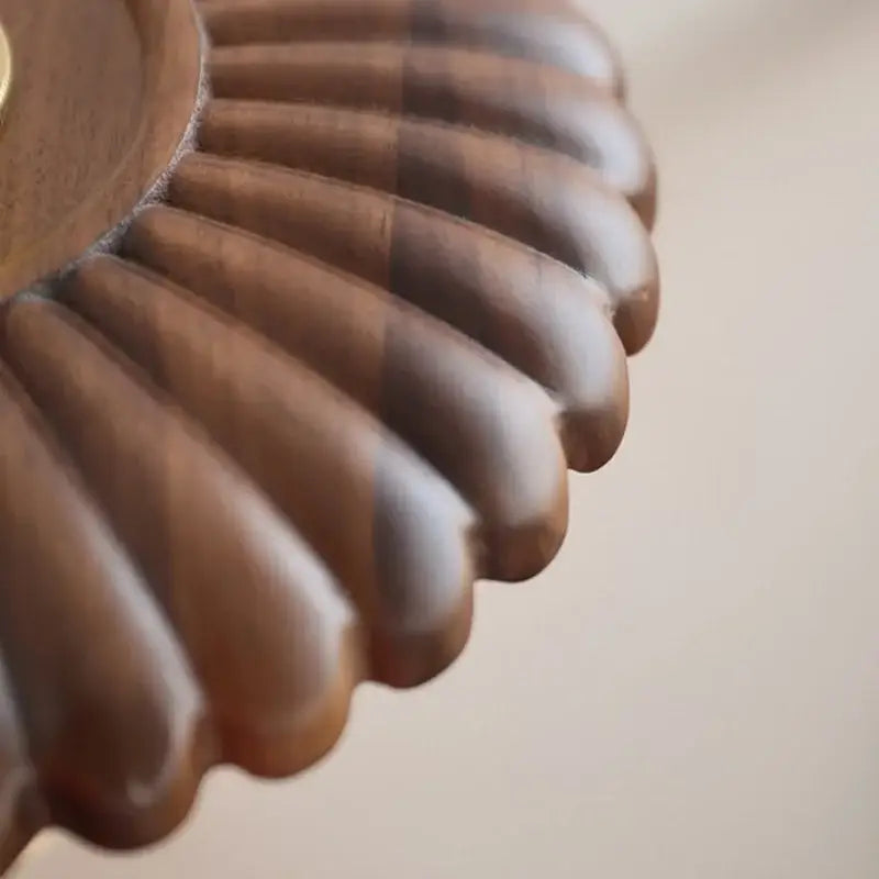 A vintage brass and amber glass wall lamp with a warm scalloped walnut wood tray by decorbites led walnut