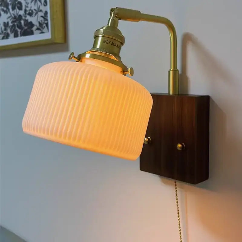 Vintage brass and amber glass wall sconce with ribbed glass ceramic led wall light and dark wood decorbites ceramic led mount