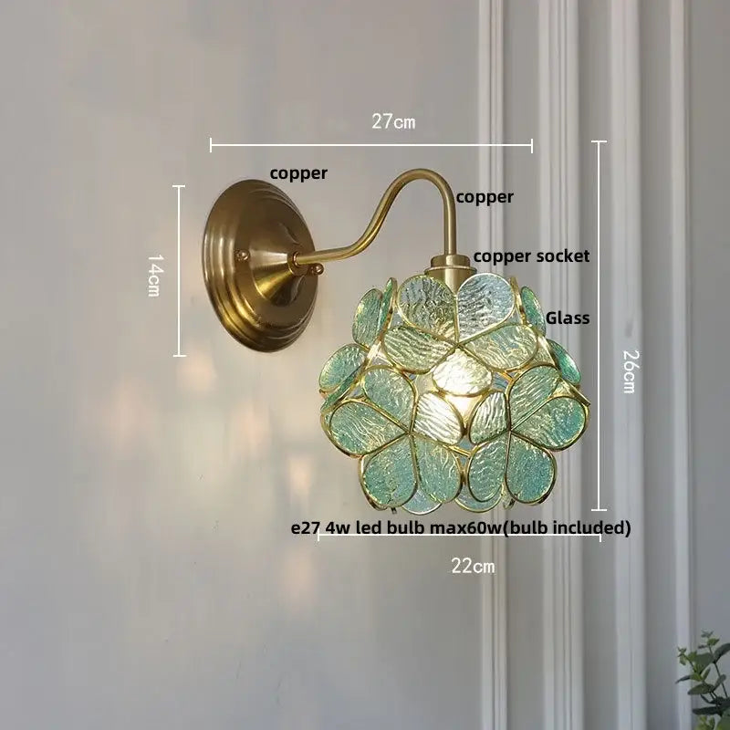Vintage brass wall sconce with decorbites amber glass and translucent green petals for bedroom vanity lighting