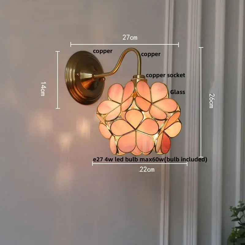 Vintage brass and amber glass wall sconce with copper finish and peach-toned stained glass petals for bedroom vanity decorbites amber glass