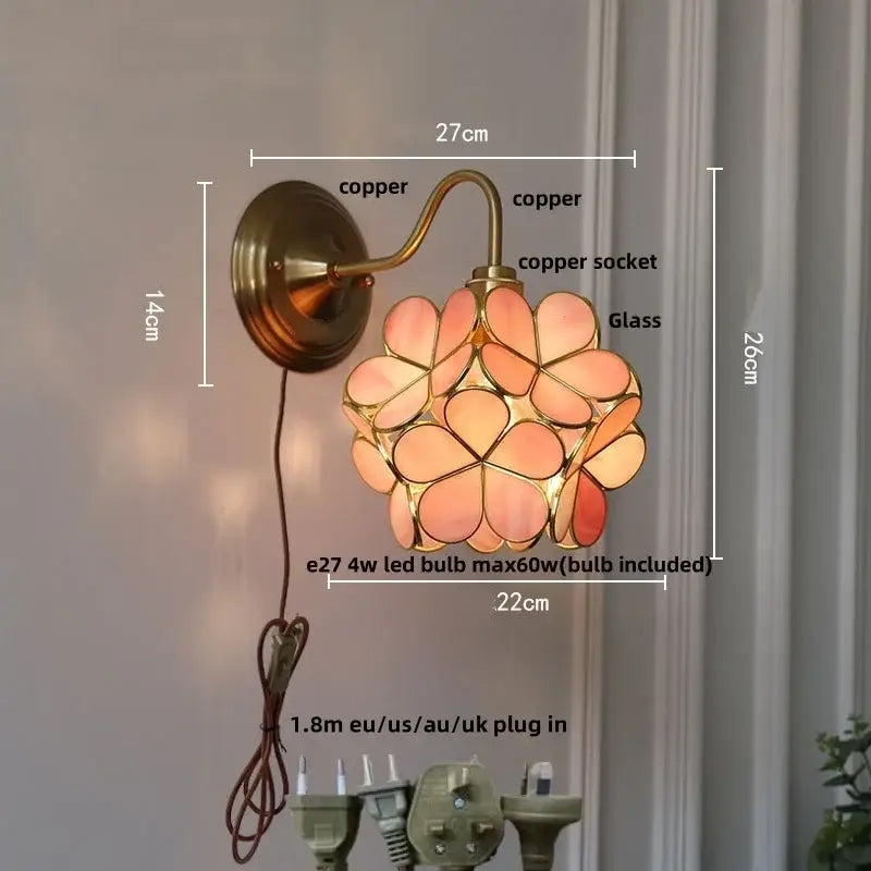 Vintage brass and decorbites amber glass wall sconce with copper finish and pink peach flower-shaped glass shade
