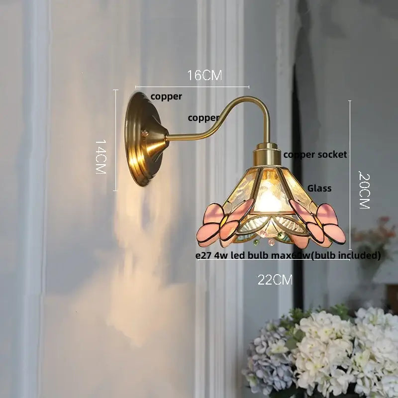 Vintage brass and amber glass wall sconce with copper finish stained glass shade featuring pink butterfly decorbites amber glass accents