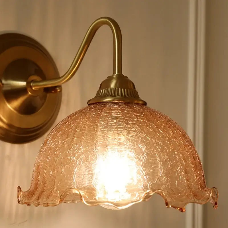 Vintage brass wall sconce with decorbites amber glass lampshade featuring a scalloped edge and crackled texture for bedroom vanity light
