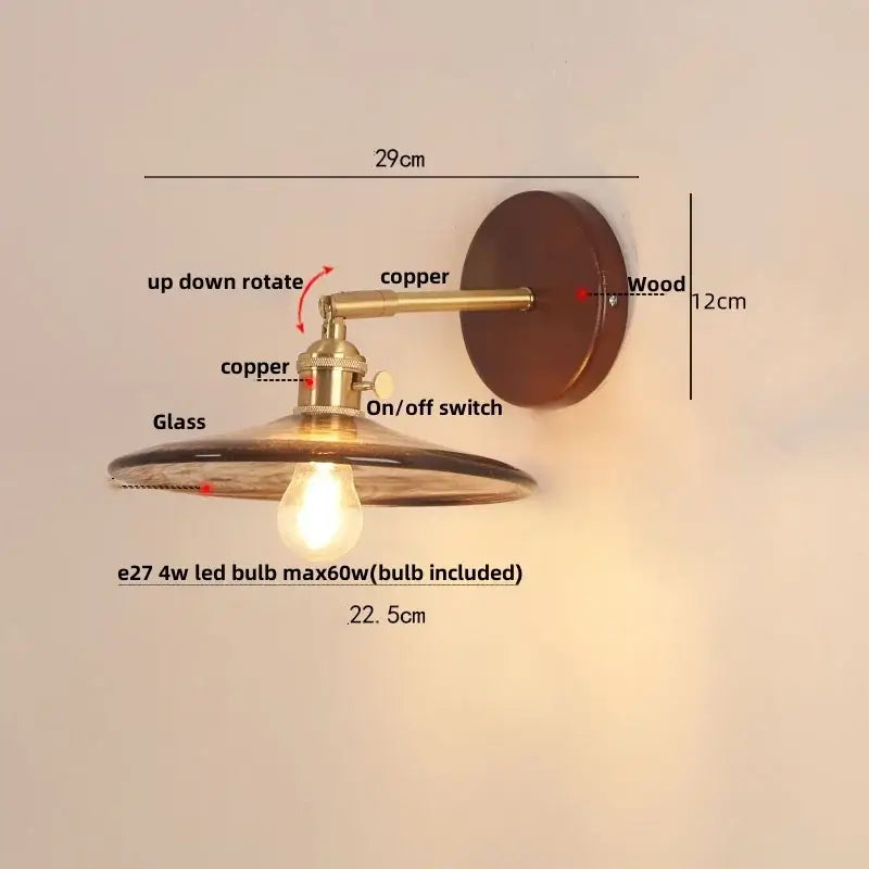 Vintage brass and amber glass wall sconce with copper and wood details and a pull chain switch for stair lighting