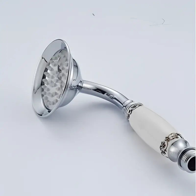 Vintage brass and bronze hand shower head faucet set featuring chrome finish, white ceramic handle, and ornate silver detailing