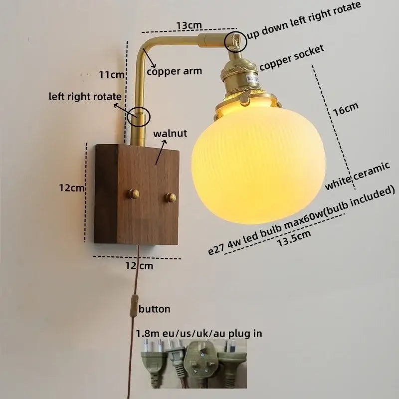 A warm glowing white ceramic led wall light with vintage brass arm and walnut wall plate for bedroom sconce lighting