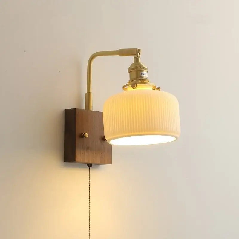 Vintage brass and ceramic led wall lights with ribbed off-white glass shade and wooden mounting plate for bedroom use