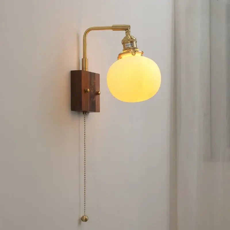 Vintage brass and ceramic led wall lights with wood sconce and frosted glass globe for bedroom use