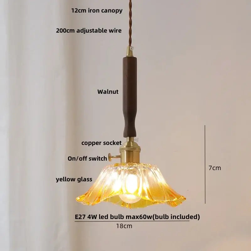 Yellow glass pendant light with walnut finished iron canopy and copper socket featuring ceramic walnut wood decorbites design