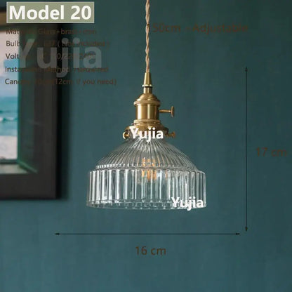 Vintage brass and clear glass pendant light with ribbed shade and adjustable cord featuring polished copper fixture