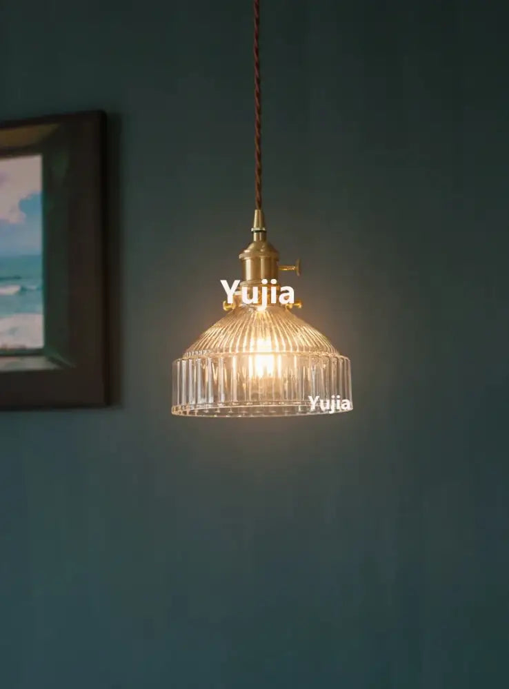 Vintage brass pendant light with clear glass ribbed shade and twisted brown cord for kitchen floral decor