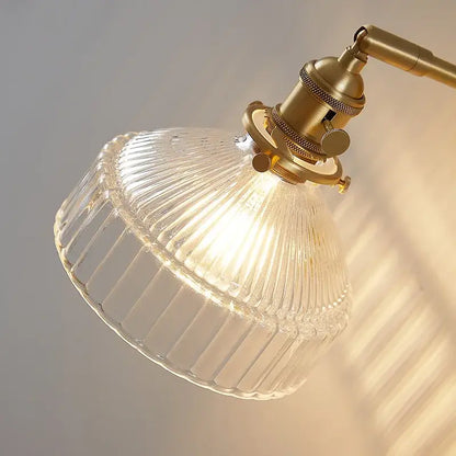 Vintage brass wall lamp with clear ribbed glass lampshade and pull chain switch for bedroom lighting
