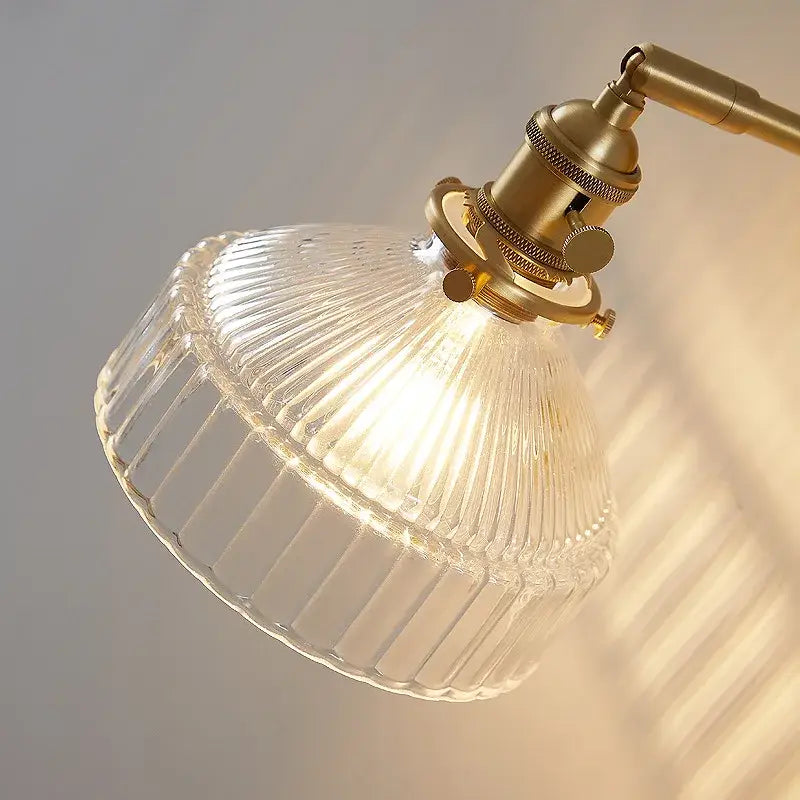 Vintage brass wall lamp with clear ribbed glass lampshade and pull chain switch for bedroom lighting