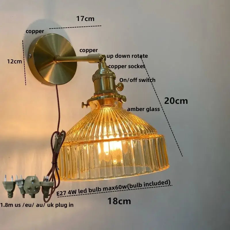 Vintage brass wall lamp with amber ribbed clear glass shade and pull chain switch for bedroom lighting