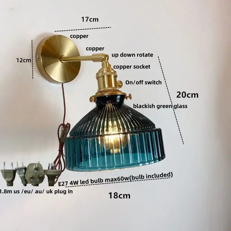 Vintage brass wall lamp with pull chain switch featuring a ribbed blackish green glass shade and copper arm