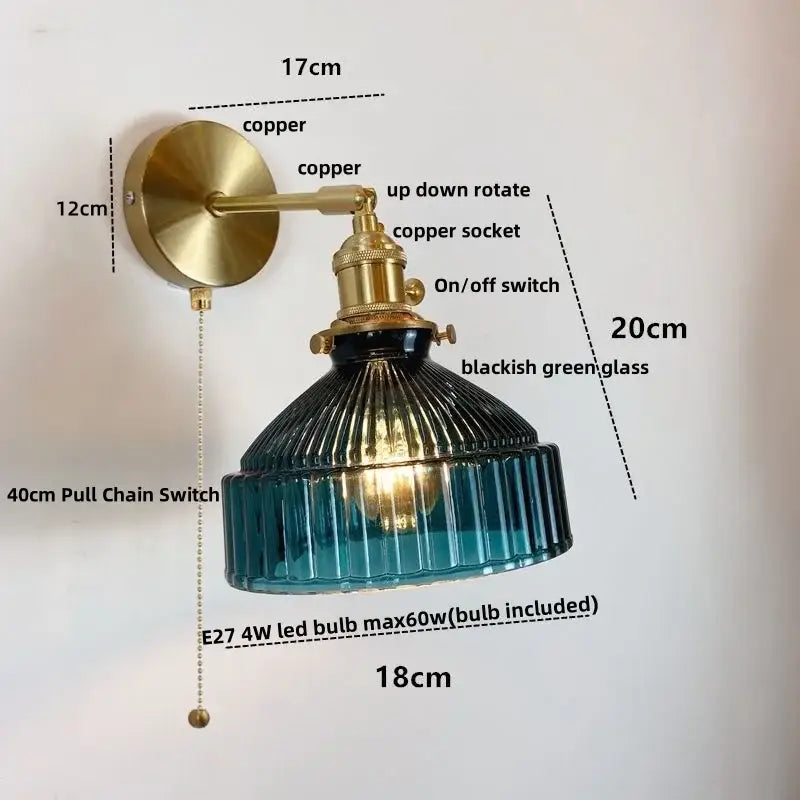 Vintage brass wall lamp with clear ribbed glass shade and pull chain switch for warm bedroom lighting