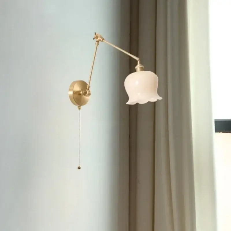 Vintage brass and cream resin led wall sconce with adjustable gold-tone arm and pale pink glass shade for decorbites cream resin lighting