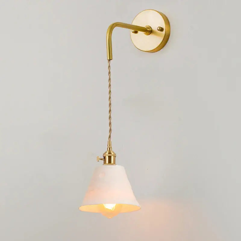 A warm-toned vintage brass wall sconce with a twisted cord and white fabric shade for decorbites ceramic led wall use