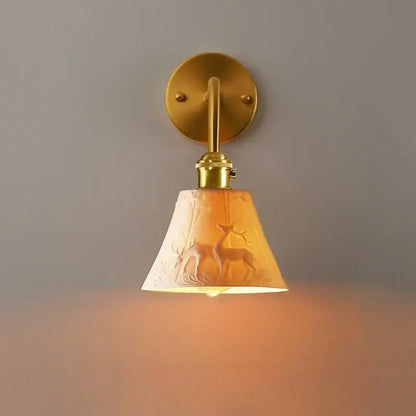 Vintage brass and frosted glass wall sconce with amber shade featuring embossed deer silhouettes decorbites ceramic led wall