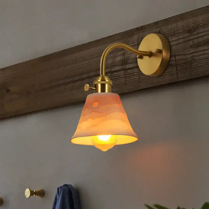 Vintage brass and frosted glass wall sconce with warm-toned ceramic led wall lampshade sunrise design by decorbites ceramic led