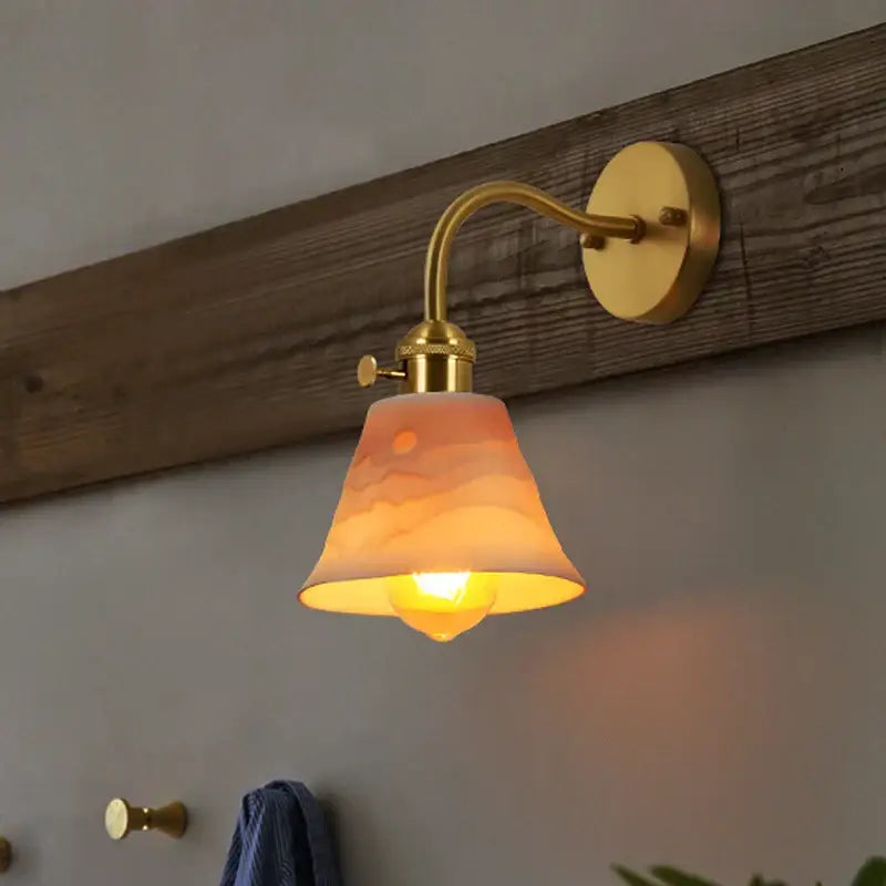 Vintage brass and frosted glass wall sconce with warm-toned ceramic led wall lampshade sunrise design by decorbites ceramic led