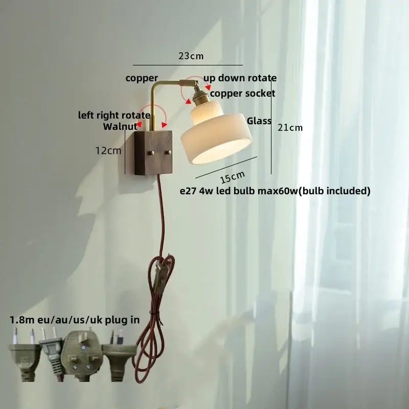 Vintage brass wall lamp with copper arm and off-white glass shade mounted on dark walnut base for bedroom use